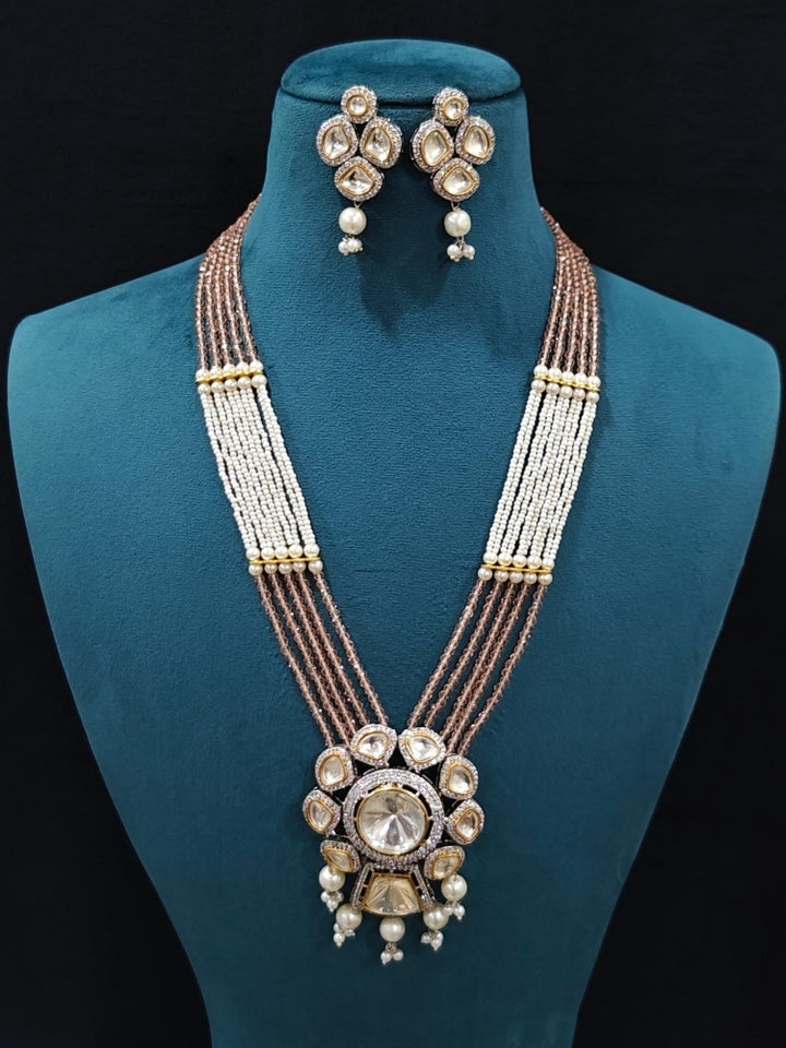 Close-up of an ornate traditional Mint Pink Long jewellery set and earrings with Kundan, American Diamond, pearls and Crystal Beads. Mehendi ceremony look completed with a handcrafted Kundan jewelry set. Wedding guest wearing a lightweight Kundan necklace for a Wedding function.