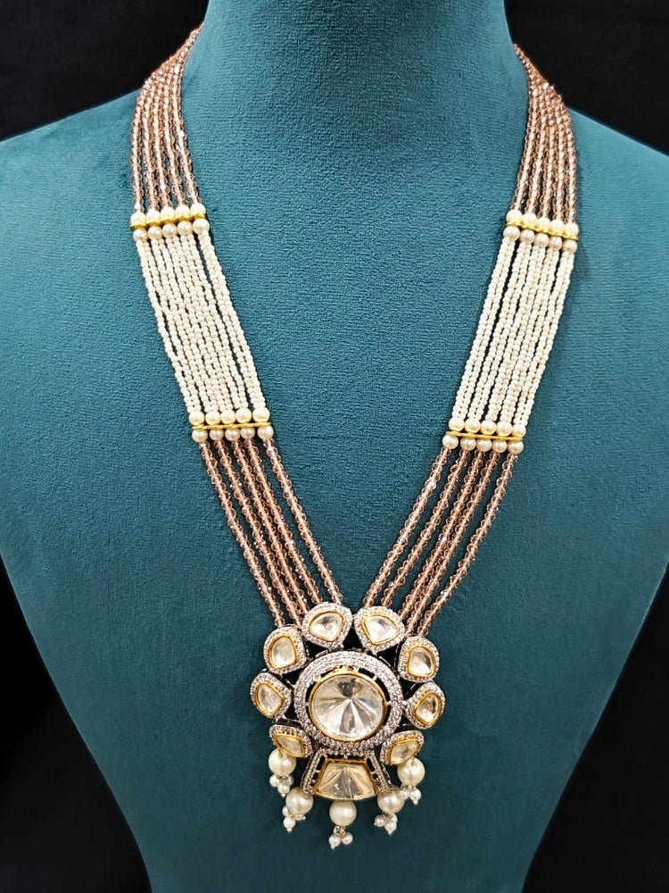 Close-up of an ornate traditional Mint Pink Long jewellery set and earrings with Kundan, American Diamond, pearls and Crystal Beads. Mehendi ceremony look completed with a handcrafted Kundan jewelry set. Wedding guest wearing a lightweight Kundan necklace for a Wedding function.