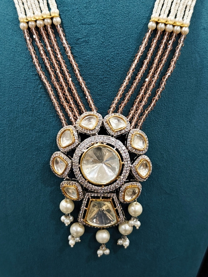 Close-up of an ornate traditional Mint Pink Long jewellery set and earrings with Kundan, American Diamond, pearls and Crystal Beads. Mehendi ceremony look completed with a handcrafted Kundan jewelry set. Wedding guest wearing a lightweight Kundan necklace for a Wedding function.