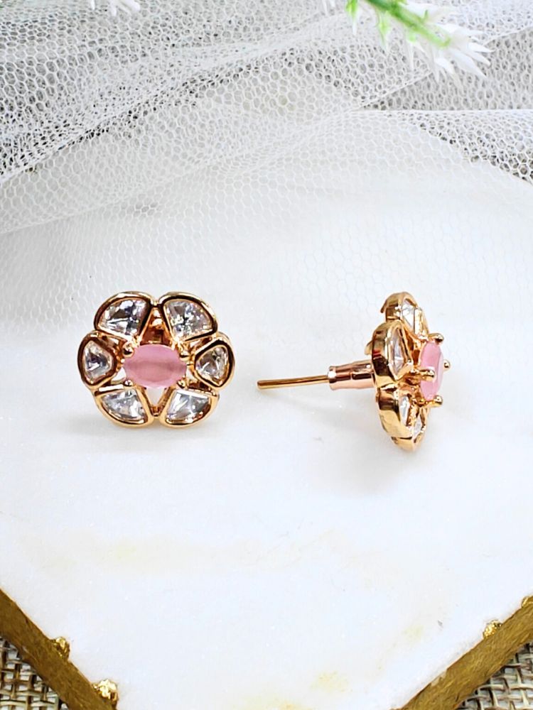 The Mint Pink Daffodil stud Earrings feature gold flower-shaped brass settings with clear American Diamond petals and a Mint Pink stone center, displayed on a white surface with sheer white fabric in the background