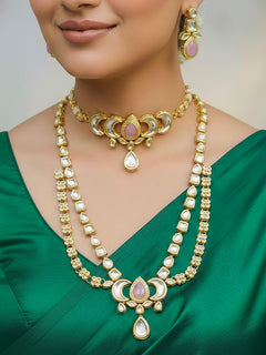 Close-up of a woman wearing an ornate traditional (Gold Polish) Mint Pink Long Kundan jewellery set and earrings and a Choker and Mangtikka with Kundan and Colored Stones. Wedding celebration look enhanced with a statement Kundan necklace. Bride wearing a royal Kundan artificial necklace for wedding rituals.