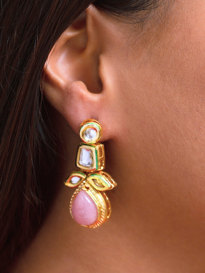 Close-up of a woman wearing an ornate traditional (Gold Polish) Mint Pink Long Kundan jewellery set and earrings and a Choker and Mangtikka with Kundan and Colored Stones. Wedding celebration look enhanced with a statement Kundan necklace. Bride wearing a royal Kundan artificial necklace for wedding rituals.