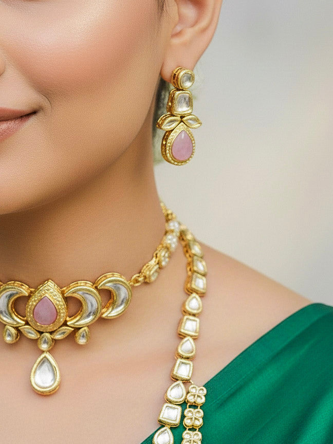 Close-up of a woman wearing an ornate traditional (Gold Polish) Mint Pink Long Kundan jewellery set and earrings and a Choker and Mangtikka with Kundan and Colored Stones. Wedding celebration look enhanced with a statement Kundan necklace. Bride wearing a royal Kundan artificial necklace for wedding rituals.