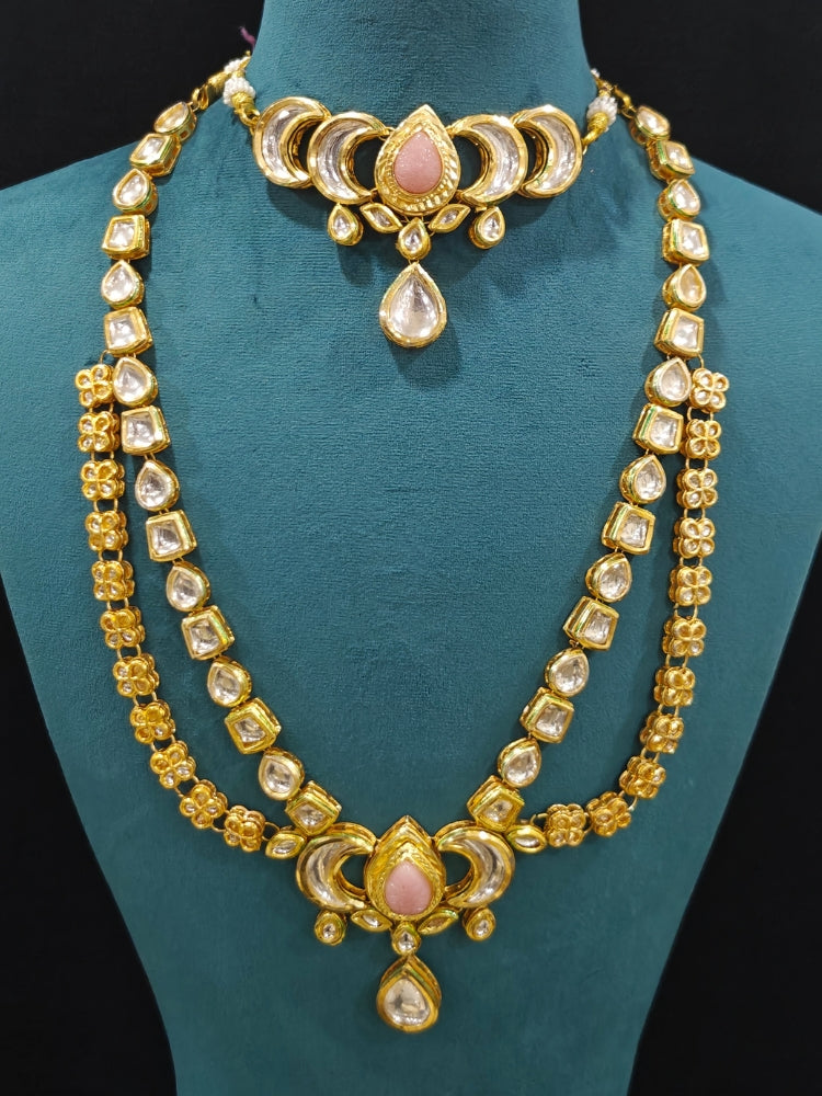 Close-up of an ornate traditional (Gold Polish) Mint Pink Long Kundan jewellery set and earrings and a Choker and Mangtikka with Kundan and Colored Stones. Wedding celebration look enhanced with a statement Kundan necklace. Bride wearing a royal Kundan artificial necklace for wedding rituals.