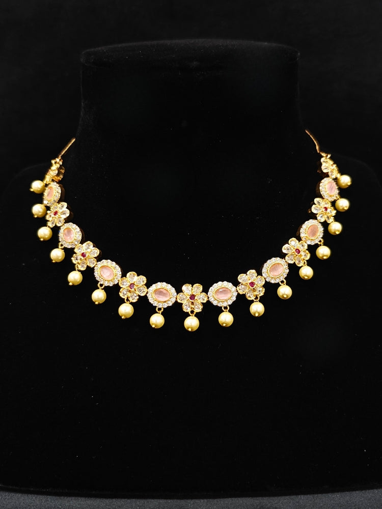 Close-up of an ornate traditional Mint Pink (gold Polish) Collar jewellery set and earrings with American diamonds, Pearls and Colored Stones. Festive Diwali outfit styled with an American diamond artificial necklace. Elegant wedding jewelry look featuring a premium artificial American diamond necklace. 