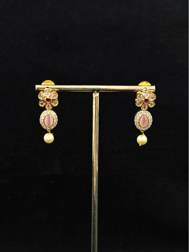 Close-up of an ornate traditional Mint Pink (gold Polish) Collar jewellery set and earrings with American diamonds, Pearls and Colored Stones. Festive Diwali outfit styled with an American diamond artificial necklace. Elegant wedding jewelry look featuring a premium artificial American diamond necklace. 
