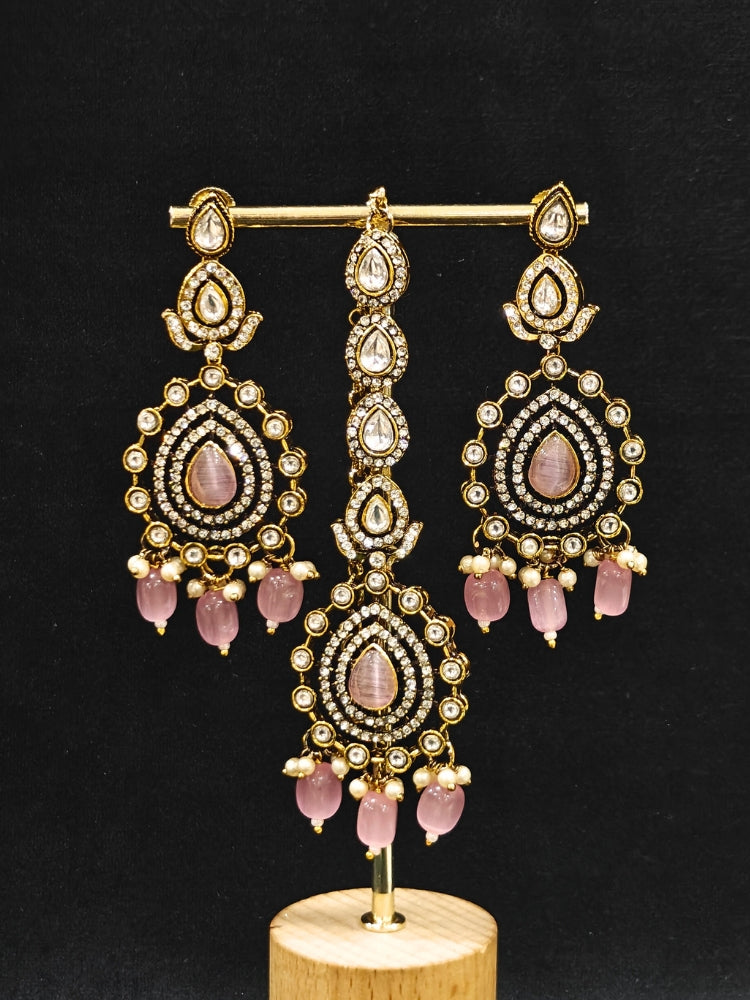 Close-up of an ornate traditional Mint Pink Diamond Collar Layered jewellery set and earrings and maangtikka with Kundan, American Diamonds, Tumble stones, Black Polish and Colored Stones. A luxury American diamond necklace set styled beautifully for a wedding guest look in India. Close-up of a bridal look featuring an anti-tarnish American diamond artificial necklace.
