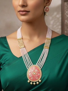 Close-up of a woman wearing an ornate traditional Mint Pink Meenakari gold Long  jewellery set and earrings with Crystal Beads, Pearls, Meenakari and Kundan. Festive Diwali outfit paired with a colorful Meenakari necklace. Reception party styling featuring a premium Meenakari imitation set.