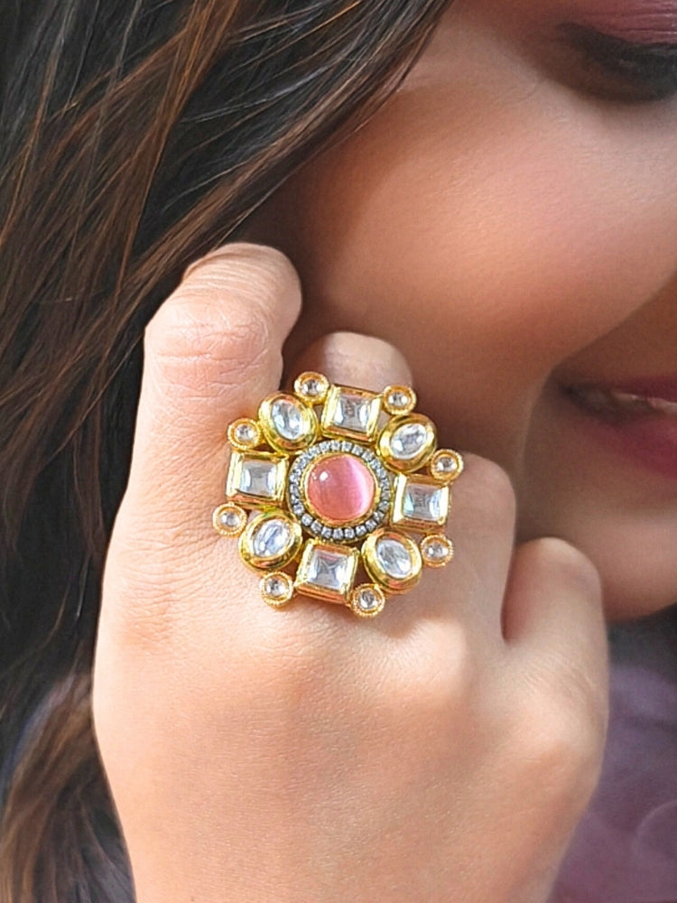 Close-up of a woman wearing an ornate traditional (Gold Polish) Mint Pink Ring with Kundan, Colored Stones and American Diamond. Bride wearing a royal Kundan artificial ring for wedding rituals. Wedding celebration look enhanced with a statement Kundan Ring.