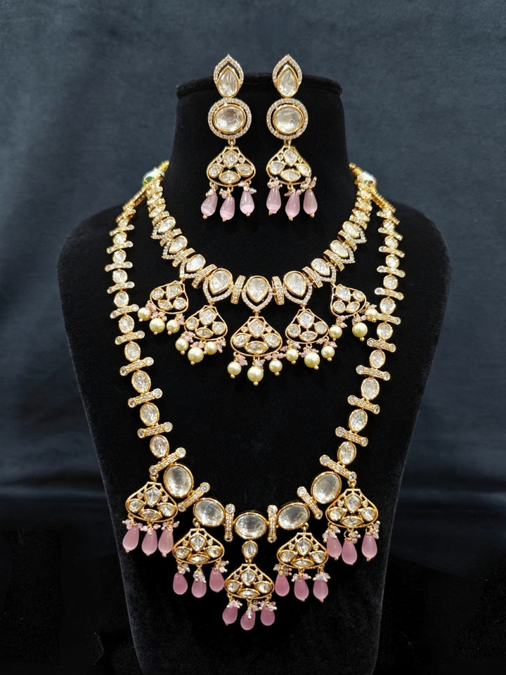 Close-up of an ornate traditional (Gold Polish) Long jewellery set and earrings with Polki, American Diamond, Tumble Beads and Pearls. Festive celebration look completed with premium imitation Polki jewelry. Woman wearing trending Polki artificial jewelry for the wedding season in India.