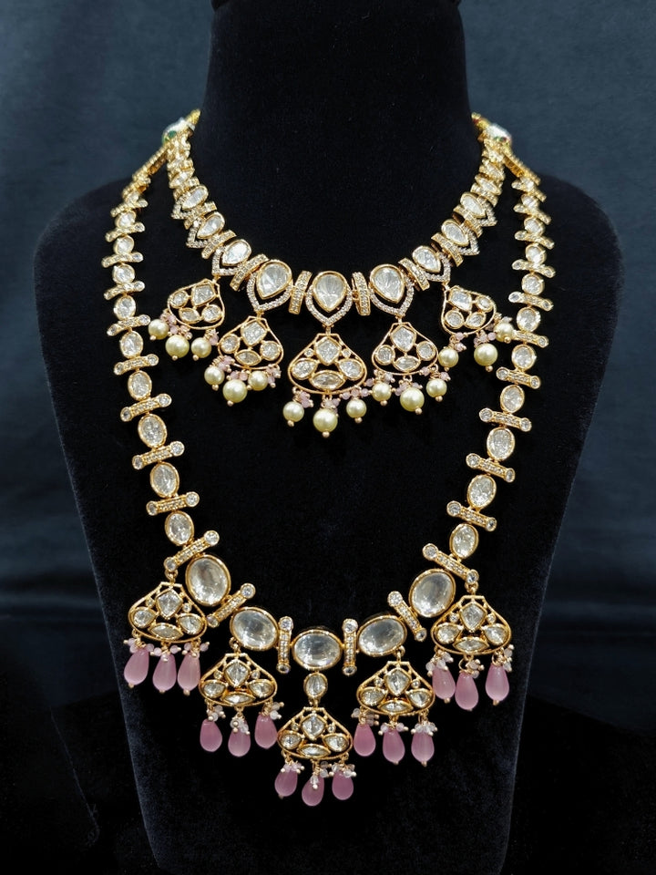 Close-up of an ornate traditional (Gold Polish) Long jewellery set and earrings with Polki, American Diamond, Tumble Beads and Pearls. Festive celebration look completed with premium imitation Polki jewelry. Woman wearing trending Polki artificial jewelry for the wedding season in India.