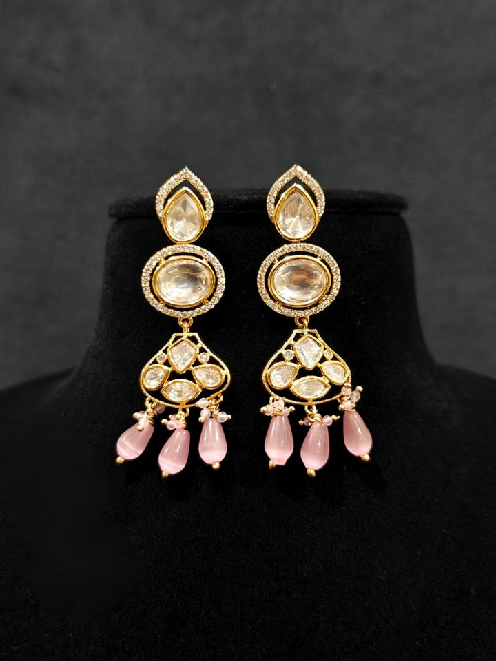 Close-up of an ornate traditional (Gold Polish) Long jewellery set and earrings with Polki, American Diamond, Tumble Beads and Pearls. Festive celebration look completed with premium imitation Polki jewelry. Woman wearing trending Polki artificial jewelry for the wedding season in India.