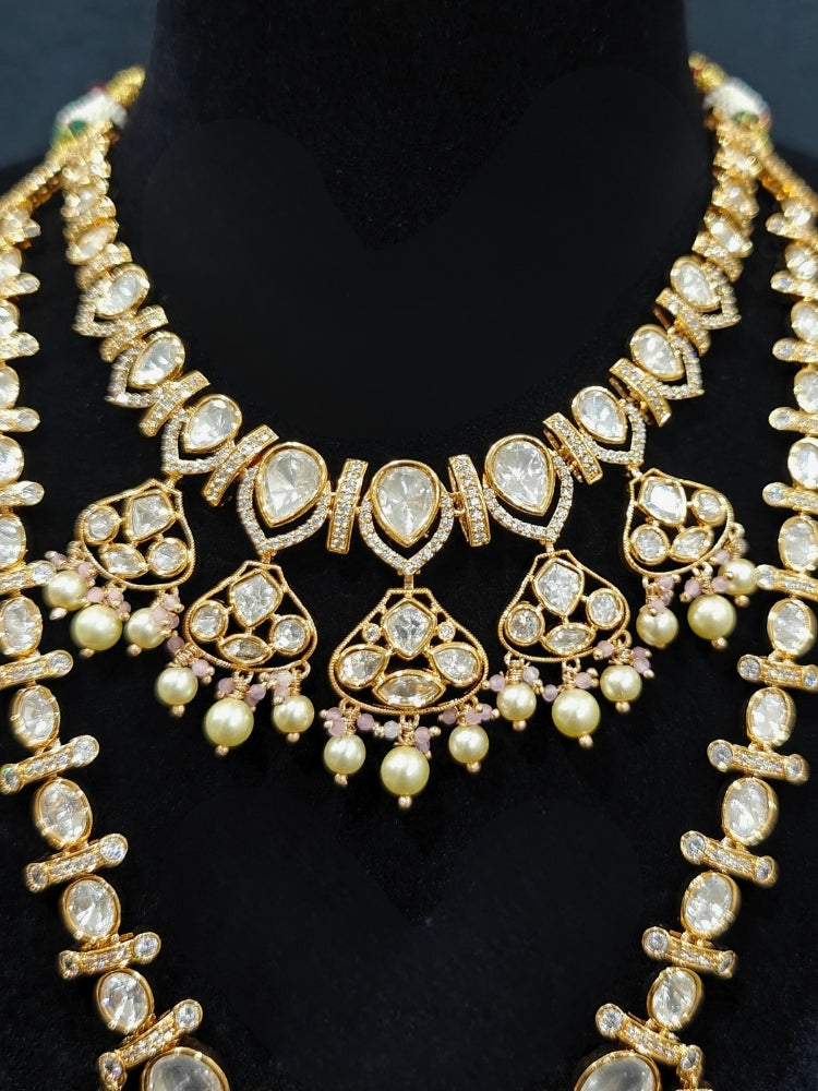 Close-up of an ornate traditional (Gold Polish) Long jewellery set and earrings with Polki, American Diamond, Tumble Beads and Pearls. Festive celebration look completed with premium imitation Polki jewelry. Woman wearing trending Polki artificial jewelry for the wedding season in India.