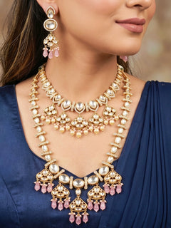 Close-up of a woman wearing an ornate traditional (Gold Polish) Long jewellery set and earrings with Polki, American Diamond, Tumble Beads and Pearls. Festive celebration look completed with premium imitation Polki jewelry.
Woman wearing trending Polki artificial jewelry for the wedding season in India.