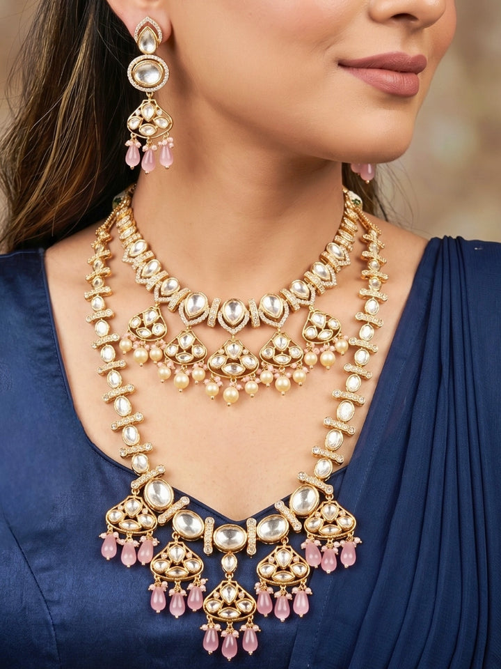 Close-up of a woman wearing an ornate traditional (Gold Polish) Long jewellery set and earrings with Polki, American Diamond, Tumble Beads and Pearls. Festive celebration look completed with premium imitation Polki jewelry.
Woman wearing trending Polki artificial jewelry for the wedding season in India.