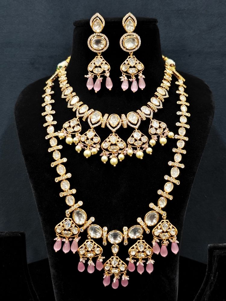Close-up of an ornate traditional (Gold Polish) Long jewellery set and earrings with Polki, American Diamond, Tumble Beads and Pearls. Festive celebration look completed with premium imitation Polki jewelry. Woman wearing trending Polki artificial jewelry for the wedding season in India.