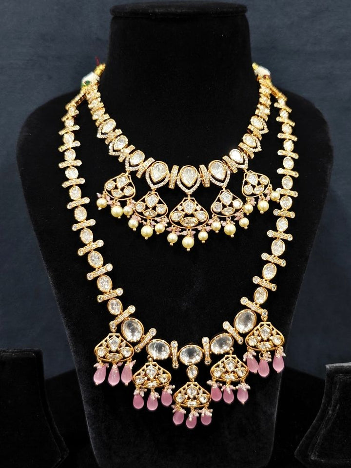 Close-up of an ornate traditional (Gold Polish) Long jewellery set and earrings with Polki, American Diamond, Tumble Beads and Pearls. Festive celebration look completed with premium imitation Polki jewelry. Woman wearing trending Polki artificial jewelry for the wedding season in India.