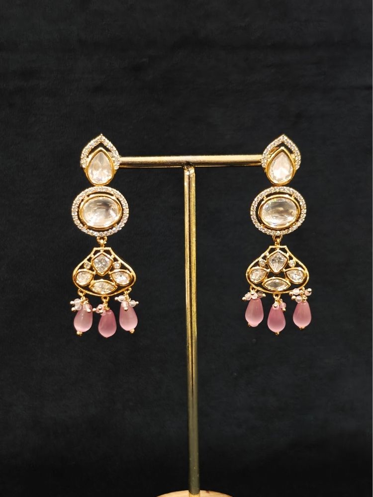 Close-up of an ornate traditional (Gold Polish) Long jewellery set and earrings with Polki, American Diamond, Tumble Beads and Pearls. Festive celebration look completed with premium imitation Polki jewelry. Woman wearing trending Polki artificial jewelry for the wedding season in India.