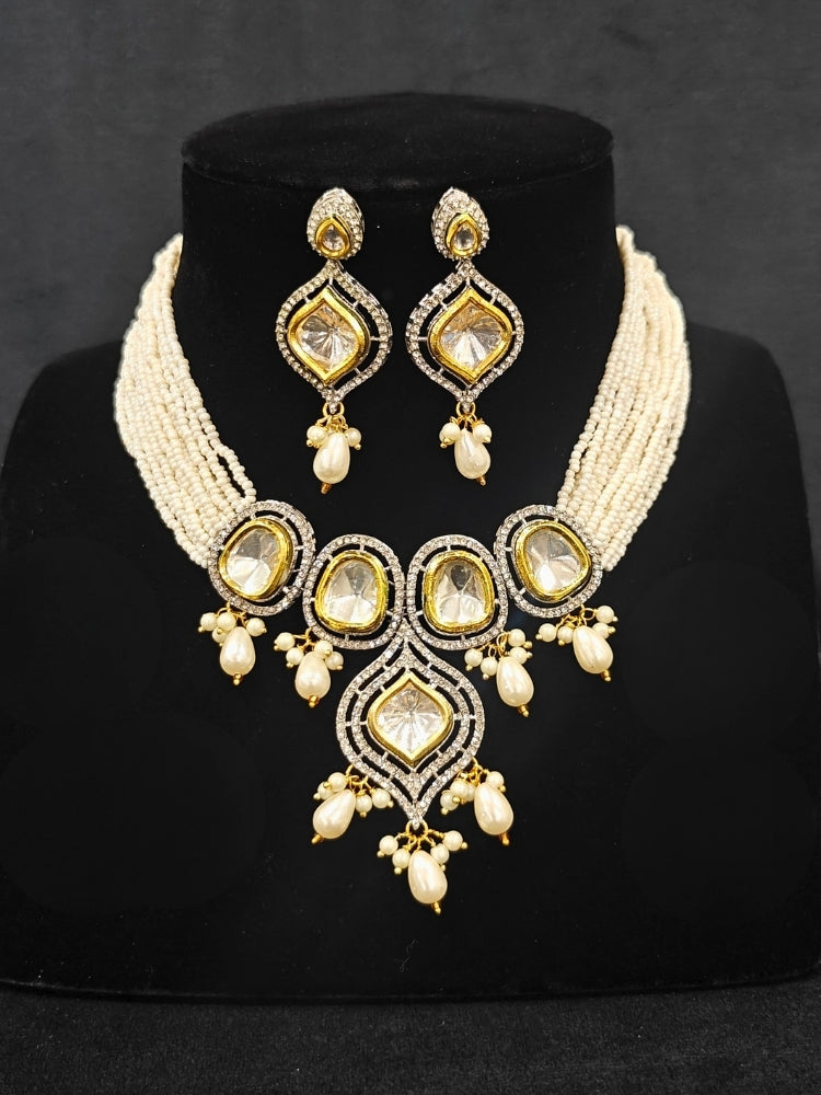 Close-up of an ornate traditional White Kundan Collar jewellery set and earrings with Moissanite Stones, American Diamonds, Pearls and Kundan. Reception party outfit paired with a luxury Kundan imitation jewelry set. Wedding celebration look enhanced with a statement Kundan necklace.