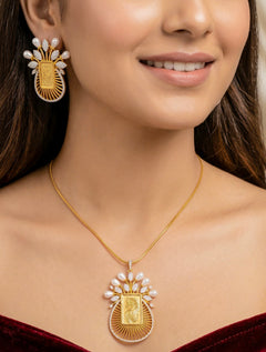 Woman wearing the Mona gold ginni pendant set with pearls and American Diamond