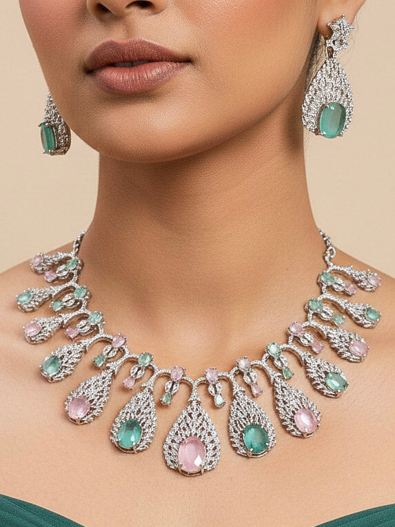 Close-up of a woman wearing an ornate Western Pink & Green Diamond Silver Collar jewellery set and earrings with American Diamond and Colored Stones. A woman wearing a luxury American diamond necklace set styled beautifully for a wedding guest look in India. Elegant wedding jewelry look featuring a premium artificial American diamond necklace.