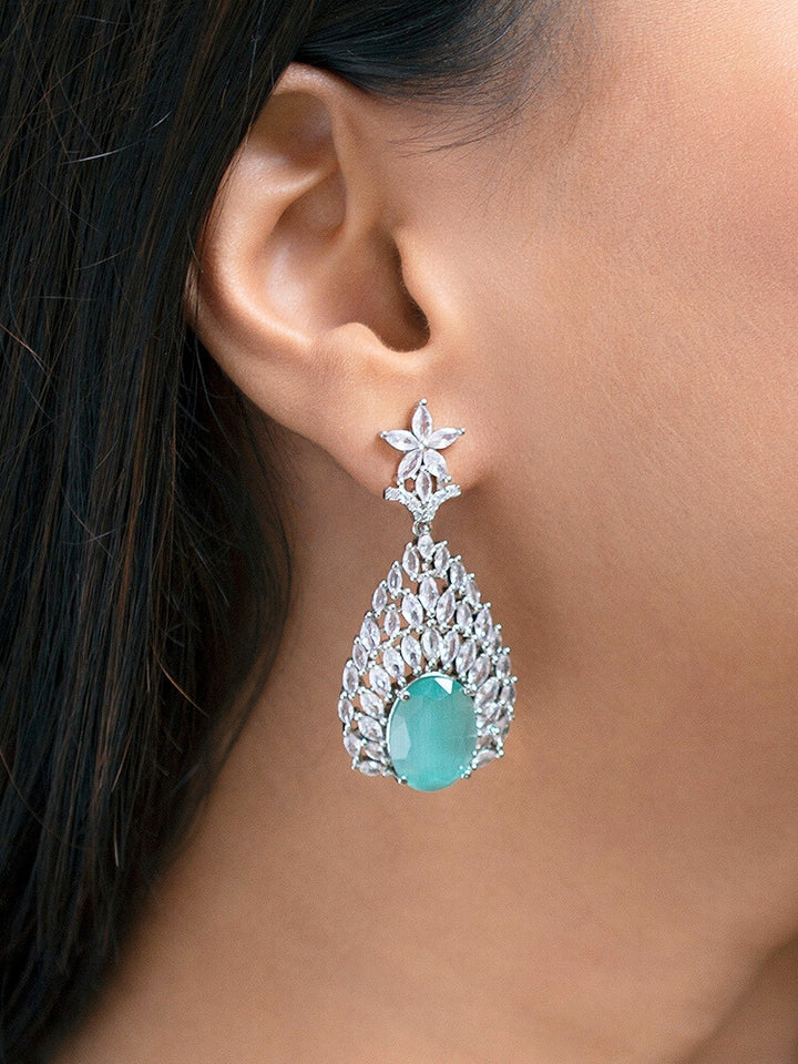 Close-up of a woman wearing an ornate Western Pink & Green Diamond Silver Collar jewellery set and earrings with American Diamond and Colored Stones. A woman wearing a luxury American diamond necklace set styled beautifully for a wedding guest look in India. Elegant wedding jewelry look featuring a premium artificial American diamond necklace.