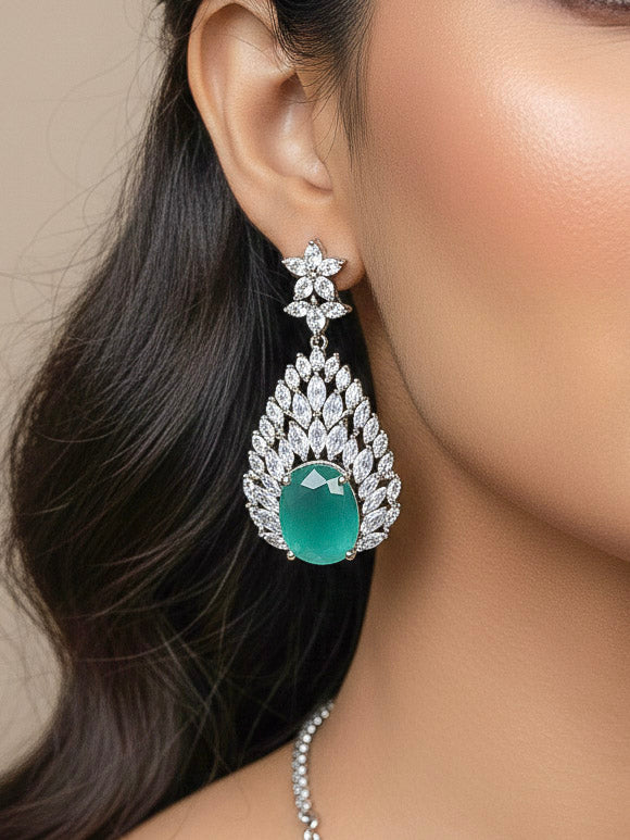 Close-up of a woman wearing an ornate Western Pink & Green Diamond Silver Collar jewellery set and earrings with American Diamond and Colored Stones. A woman wearing a luxury American diamond necklace set styled beautifully for a wedding guest look in India. Elegant wedding jewelry look featuring a premium artificial American diamond necklace.