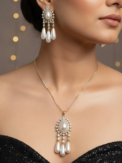 Close-up of a woman wearing an ornate Indo-western White Diamond Pendant set and earrings with Pearls and American Diamond. Festive Diwali outfit styled with an American diamond artificial Pendant. Party wear outfit completed with a lightweight American diamond Pendant.