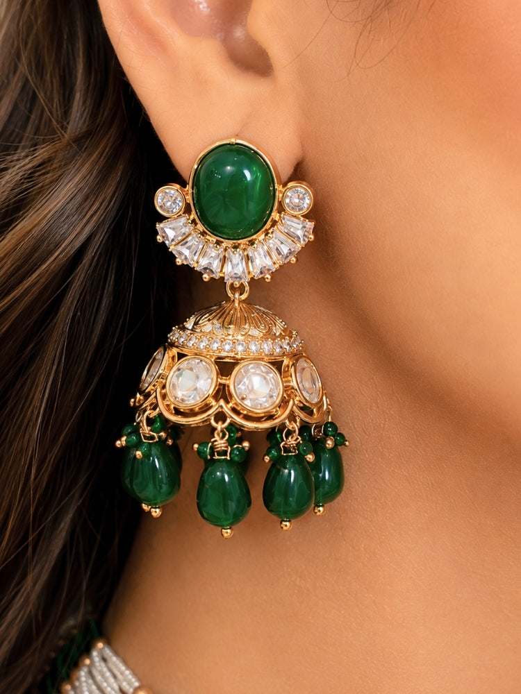 Close-up of a woman wearing an ornate traditional (Gold Polish) Choker Dark Green jewellery set and earrings with Crystal Beads, Polki, American Diamond, Colored Stones and Pearls. Festive Diwali look enhanced with a premium Polki artificial necklace. Festive saree look completed with Polki artificial jewelry set.
