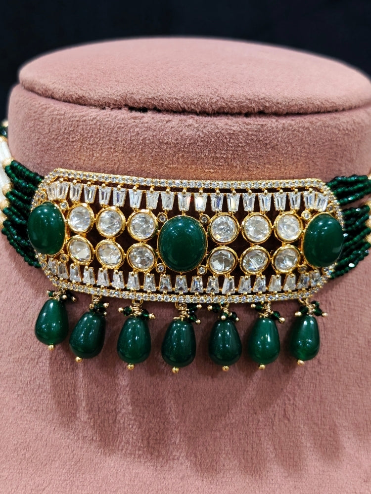 Close-up of an ornate traditional (Gold Polish) Choker Dark Green jewellery set and earrings with Crystal Beads, Polki, American Diamond, Colored Stones and Pearls. Festive Diwali look enhanced with a premium Polki artificial necklace. Festive saree look completed with Polki artificial jewelry set.