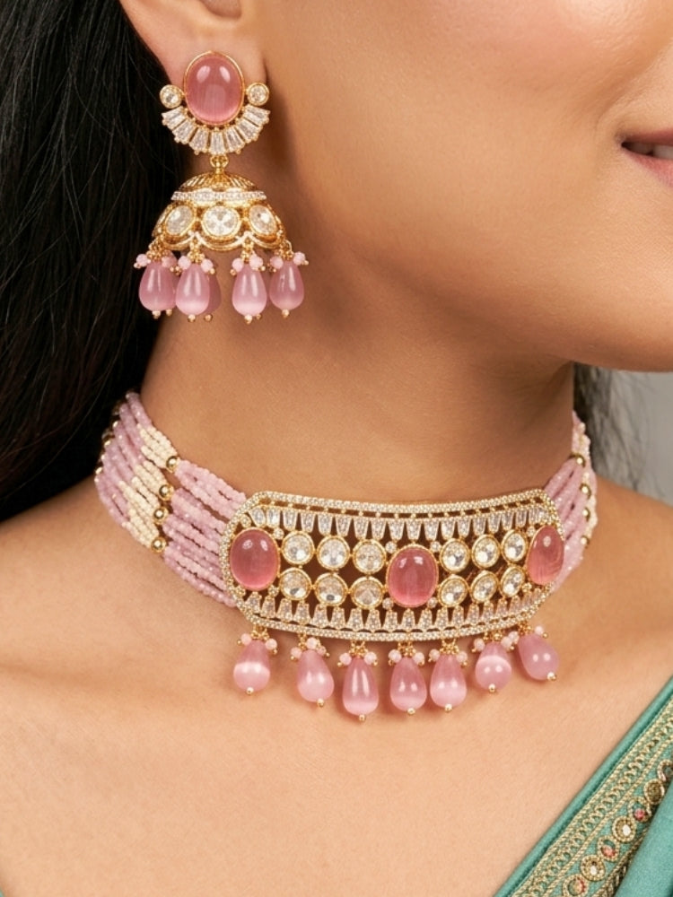 Close-up of a woman wearing an ornate traditional (Gold Polish) Choker Mint Pink jewellery set and earrings with Crystal Beads, Polki, American Diamond, Colored Stones and Pearls. Festive Diwali look enhanced with a premium Polki artificial necklace. Festive saree look completed with Polki artificial jewelry set.