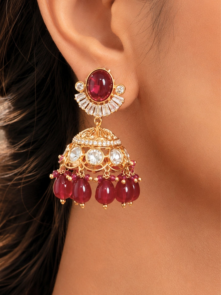 Close-up of a woman wearing an ornate traditional (Gold Polish) Choker Ruby Pink jewellery set and earrings with Crystal Beads, Polki, American Diamond, Colored Stones and Pearls. Festive Diwali look enhanced with a premium Polki artificial necklace. Festive saree look completed with Polki artificial jewelry set.