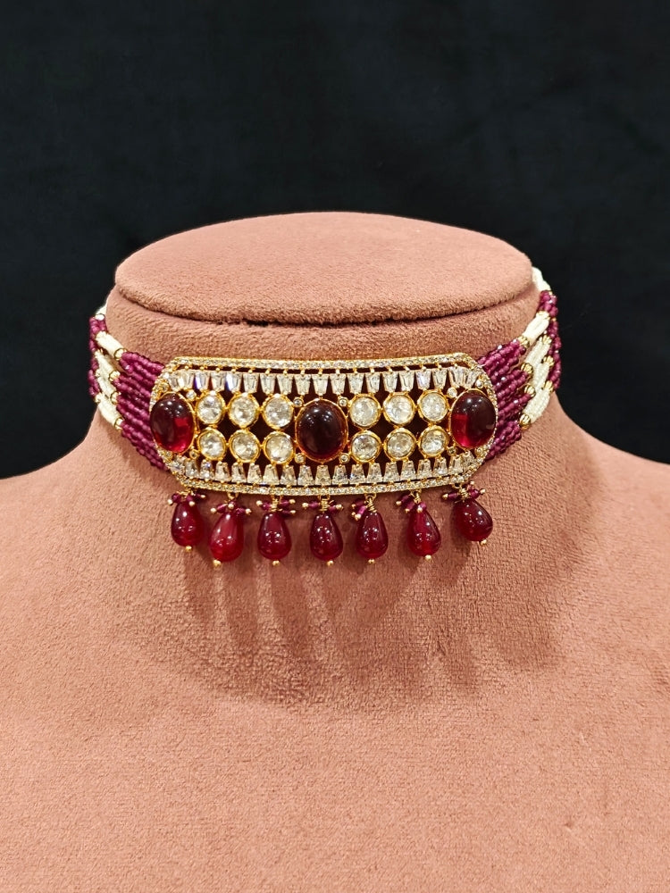 Close-up of an ornate traditional (Gold Polish) Choker Ruby Pink jewellery set and earrings with Crystal Beads, Polki, American Diamond, Colored Stones and Pearls. Festive Diwali look enhanced with a premium Polki artificial necklace. Festive saree look completed with Polki artificial jewelry set.