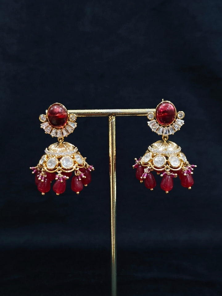 Close-up of an ornate traditional (Gold Polish) Choker Ruby Pink jewellery set and earrings with Crystal Beads, Polki, American Diamond, Colored Stones and Pearls. Festive Diwali look enhanced with a premium Polki artificial necklace. Festive saree look completed with Polki artificial jewelry set.