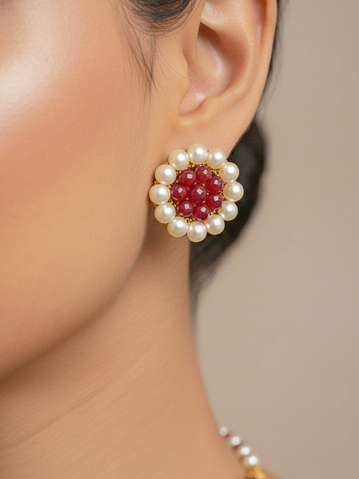 Close-up of a woman wearing an ornate traditional Red & White Layered Jewellery set and Earring with Pearls and Crystal Beads. Mehendi ceremony look completed with a handcrafted Pearl jewelry set. Mehendi ceremony look completed with a handcrafted Pearl jewelry set.