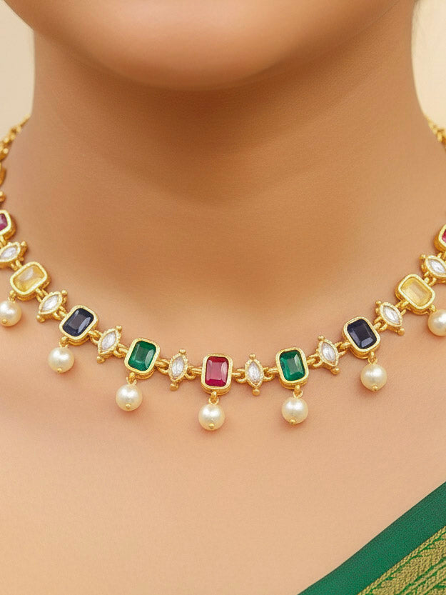 Close-up of a woman wearing an ornate traditional (Gold Polish) Multi-color Choker jewellery set and earrings with Colored Stones, Pearl and American Diamonds. Festive Diwali outfit styled with an Colored Stones artificial necklace. Mehendi function outfit styled with a Colored Stone  necklace set.