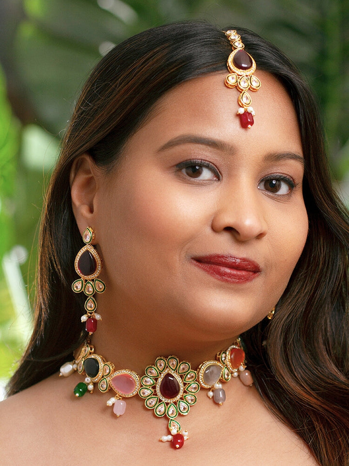 Close-up of a woman wearing an ornate traditional Multi-Color Choker jewellery set and earrings and maangtikka with Kundan, Monalisa Stone, American Diamonds, Beads and Reverse American Diamonds and tumble stones. A graceful woman wearing a trending Colored Stone necklace for a 2026 wedding celebration. Elegant wedding jewelry look featuring a premium artificial Colored Stone necklace.