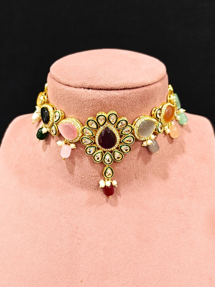 Close-up of an ornate traditional Multi-Color Choker jewellery set and earrings and maangtikka with Kundan, Monalisa Stone, American Diamonds, Beads and Reverse American Diamonds and tumble stones. A graceful woman wearing a trending Colored Stone necklace for a 2026 wedding celebration. Elegant wedding jewelry look featuring a premium artificial Colored Stone necklace.