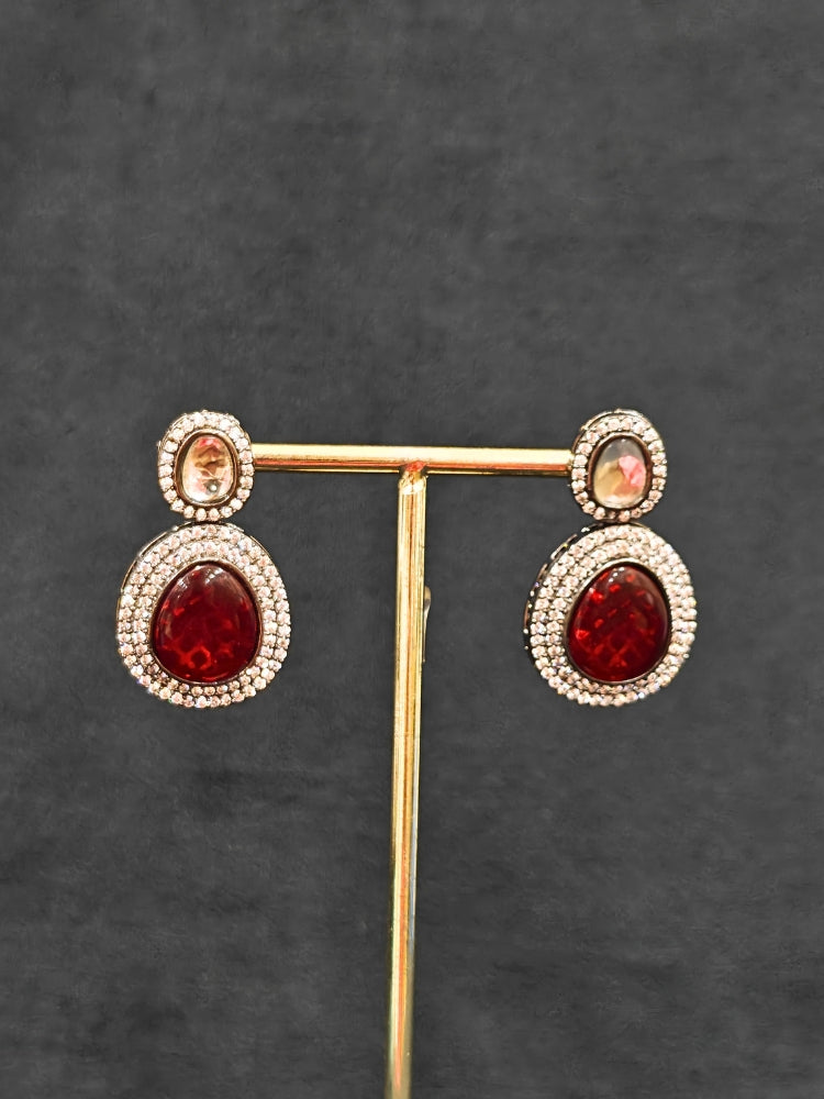 Close-up of ornate Indo-western American Diamond Multi-Color Collar jewellery set and earrings with American Diamonds and Monalisa Stones. Woman styling a statement American diamond necklace with an off-shoulder gown for a reception. Close-up of a luxury American Diamond imitation necklace styled.