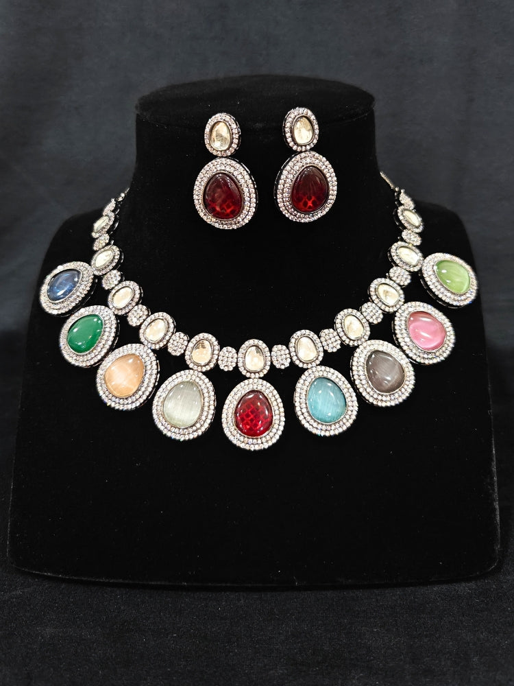 Close-up of ornate Indo-western American Diamond Multi-Color Collar jewellery set and earrings with American Diamonds and Monalisa Stones. Woman styling a statement American diamond necklace with an off-shoulder gown for a reception. Close-up of a luxury American Diamond imitation necklace styled.