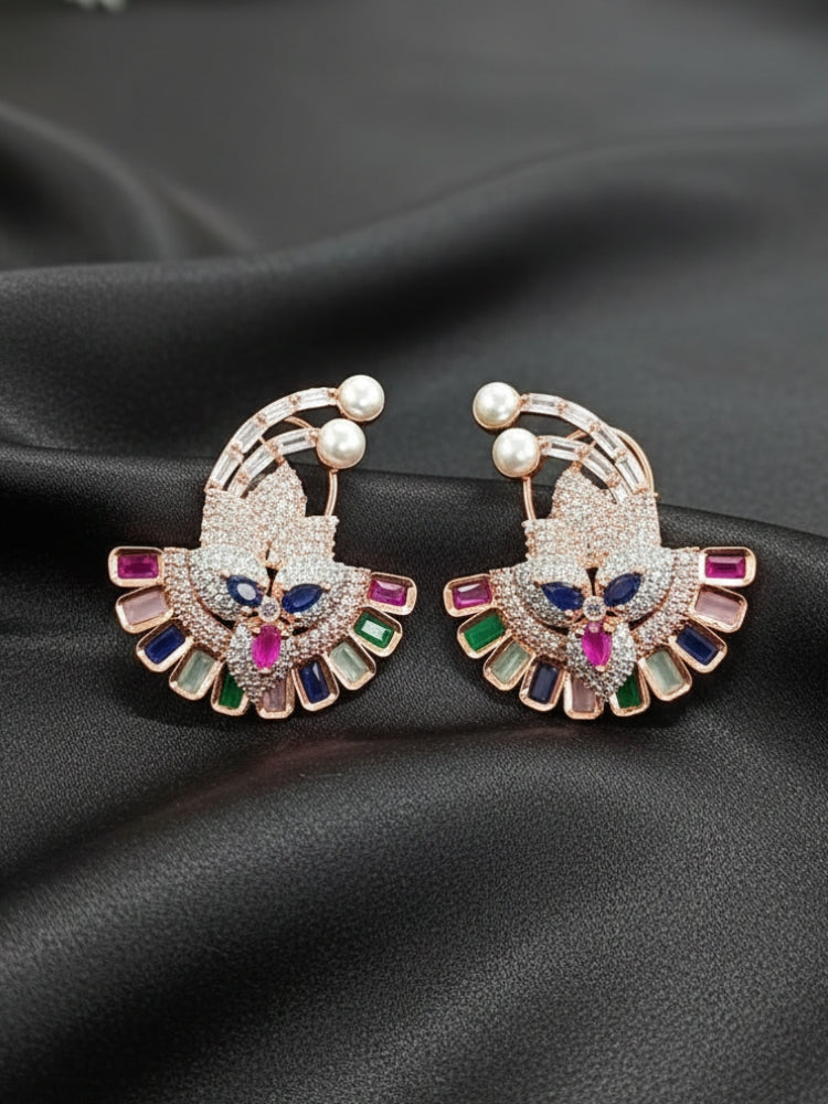 Close-up of a woman wearing an ornate Indo-western Multi-Color (Rose gold Polish) Diamond Studs Earrings with American Diamond and Colored Stones. Mehendi function outfit styled with a lightweight American Diamond Studs Earrings. 