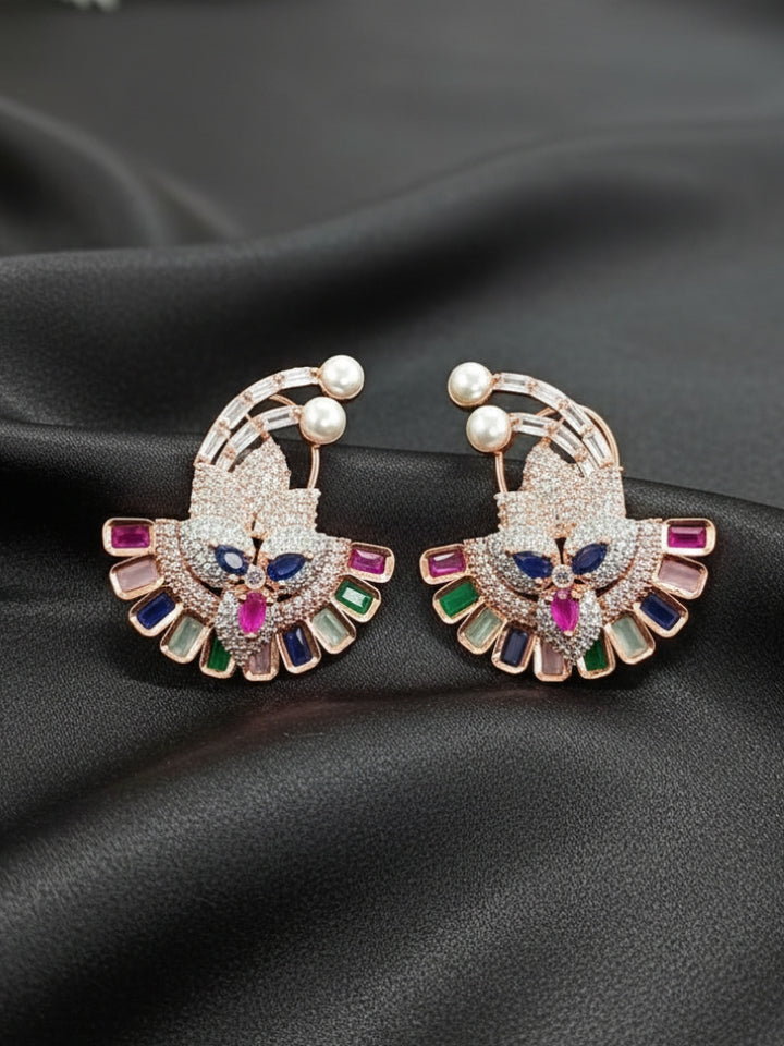 Close-up of a woman wearing an ornate Indo-western Multi-Color (Rose gold Polish) Diamond Studs Earrings with American Diamond and Colored Stones. Mehendi function outfit styled with a lightweight American Diamond Studs Earrings. 