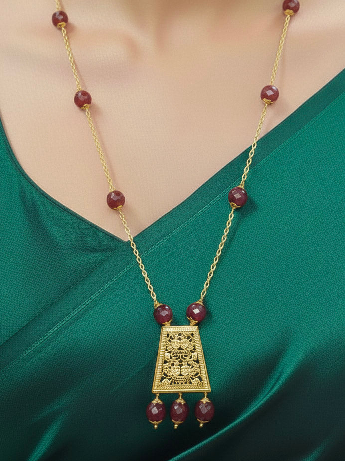Close-up of a woman wearing an ornate traditional (Gold Polish) Long jewellery set and earrings with Filigree work and Red Colored Beads. Mehendi ceremony look completed with a handcrafted jewelry set.
Festive Diwali outfit paired with a colorful  necklace.