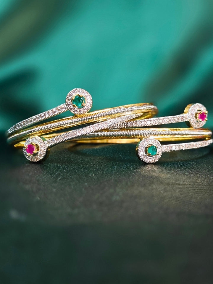 Close-up of an ornate  Indo-Western (Silver & Gold Polish) Diamond Bangles with American Diamond and Colored stones. Elegant party wear styled with high-quality imitation American Diamond Bangles. Close-up of American diamond Bangles styled for a reception party.