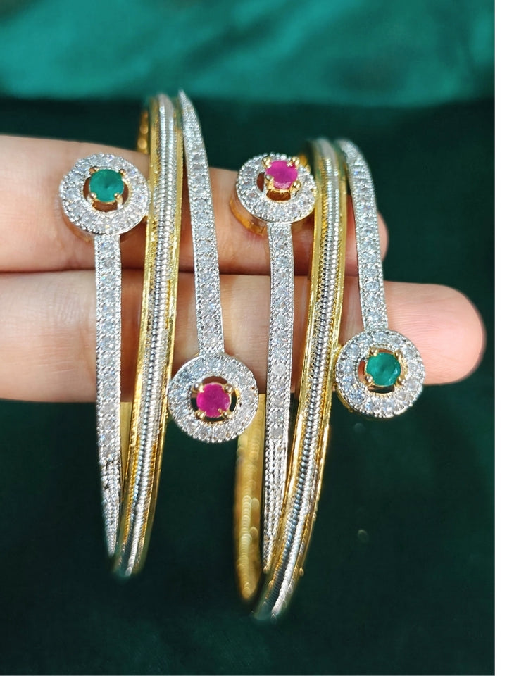 Close-up of an ornate  Indo-Western (Silver & Gold Polish) Diamond Bangles with American Diamond and Colored stones. Elegant party wear styled with high-quality imitation American Diamond Bangles. Close-up of American diamond Bangles styled for a reception party.