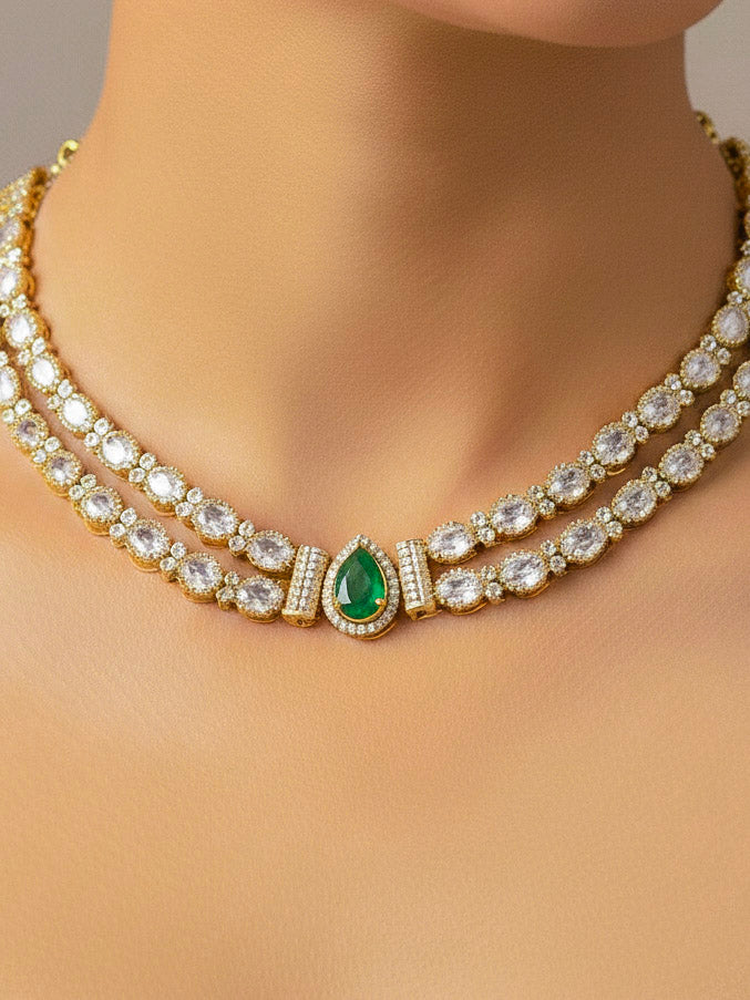Close-up of a woman wearing an ornate Indo-western Green Collar Layered Diamond jewellery set and earrings with American Diamond and Colored Stones. Festive Diwali outfit styled with an American diamond artificial necklace. Party wear outfit completed with a lightweight American diamond necklace.