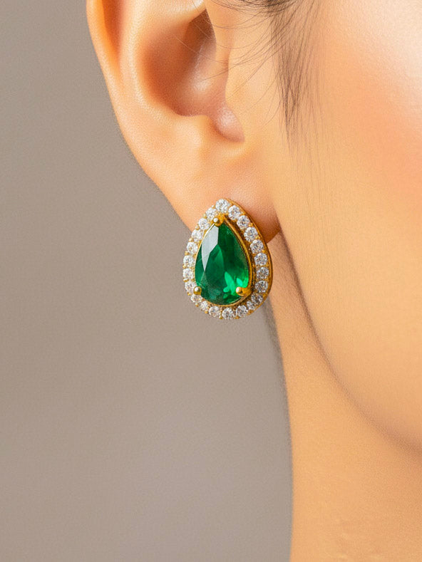 Close-up of a woman wearing an ornate Indo-western Green Collar Layered Diamond jewellery set and earrings with American Diamond and Colored Stones. Festive Diwali outfit styled with an American diamond artificial necklace. Party wear outfit completed with a lightweight American diamond necklace.