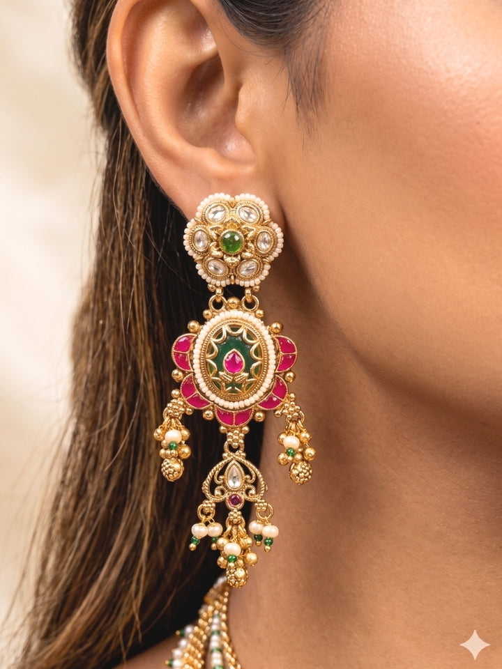 Close-up of a woman wearing an ornate traditional Mint Green Heritage gold Collar jewellery set and earrings with Pearls and Colored Stone. Saree styling inspiration with a traditional heritage necklace. Close-up of intricate antique finishing in heritage imitation jewelry.