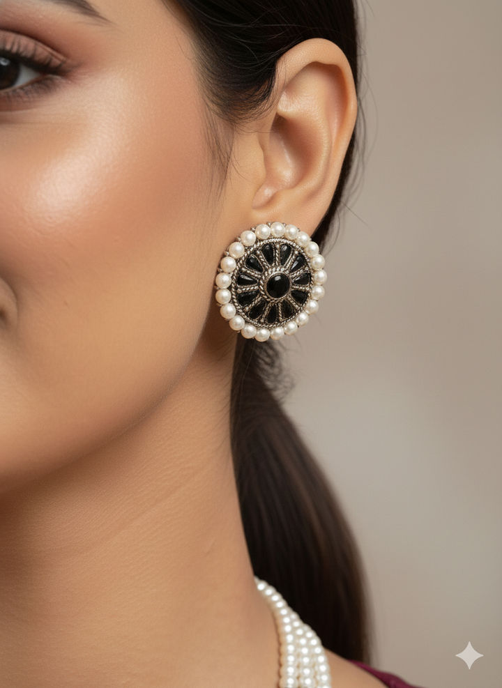 Close-up of a woman wearing an ornate Indo-Western White and Black Layered Jewellery Set and Earrings with Pearls and BLack Colored Beads. Indo-western outfit styled with an artifical Pearl Necklace Set. 