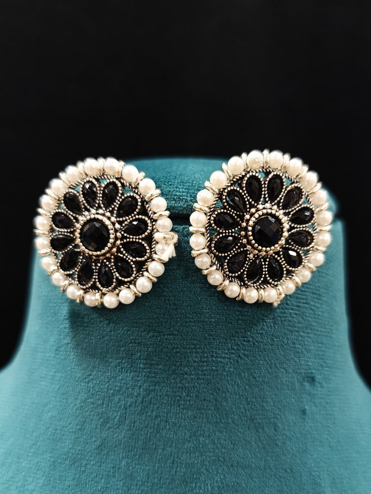 Close-up of an ornate Indo-Western White and Black Layered Jewellery Set and Earrings with Pearls and BLack Colored Beads. Indo-western outfit styled with an artifical Pearl Necklace Set. 